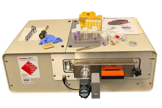 ALD instrument with sample vials and tools on top; background edited